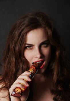 Photo by Jordane Mathieu | ILikeGuru woman biting on chocolate bar